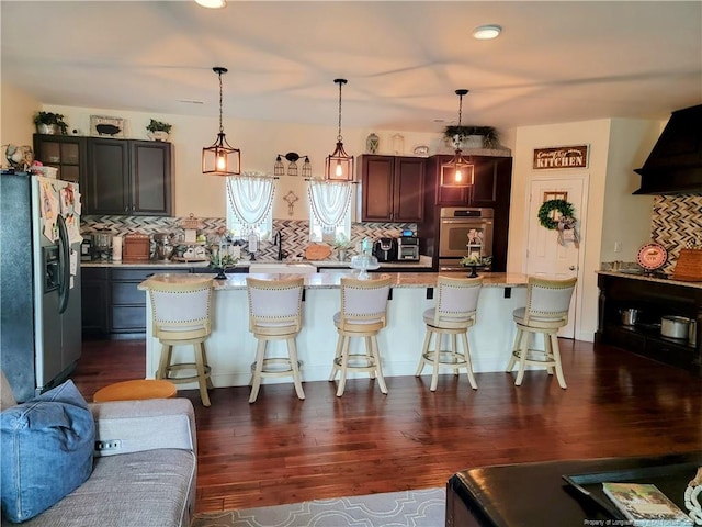 41 Lenor Dr, Lumberton, NC 28360 - kitchen with pendant lighting, a breakfast bar, dark wood-style floors, stainless steel appliances, and decorative backsplash