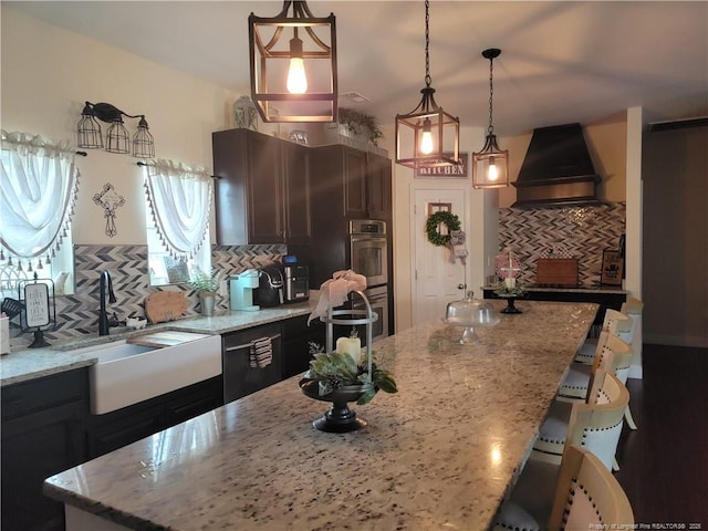 41 Lenor Dr, Lumberton, NC 28360 - kitchen with a kitchen bar, custom range hood, light stone counters, and tasteful backsplash