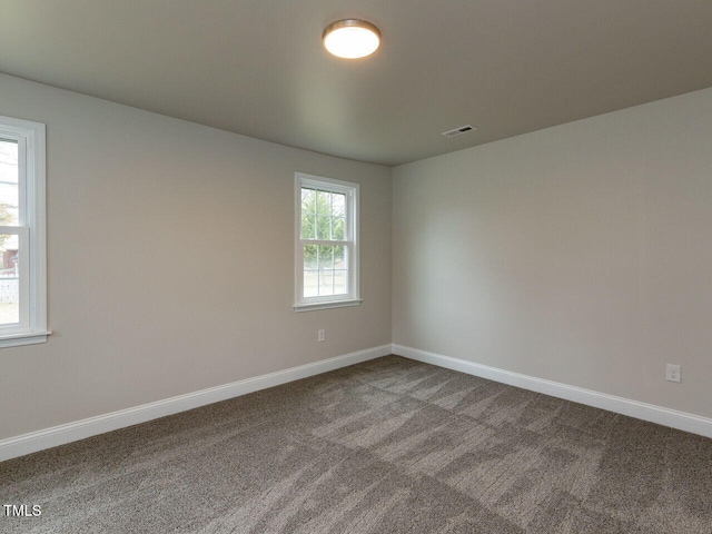 carpeted spare room with baseboards