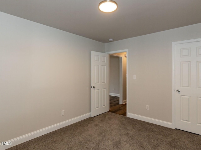 unfurnished bedroom featuring carpet flooring and baseboards