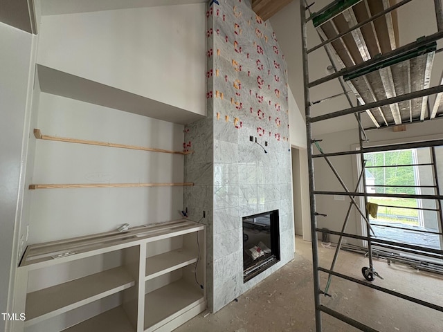 3405 Makers Cir, Raleigh, NC 27612 - unfurnished bedroom featuring concrete floors and a tiled fireplace