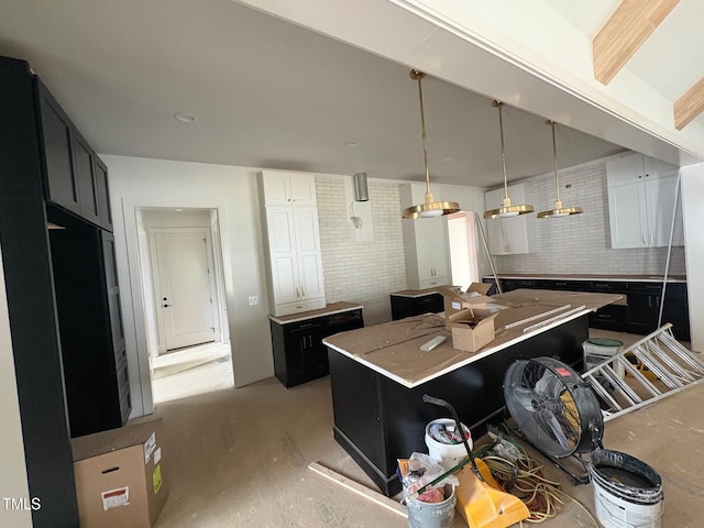 3405 Makers Cir, Raleigh, NC 27612 - kitchen with dark cabinetry, a kitchen island, and hanging light fixtures