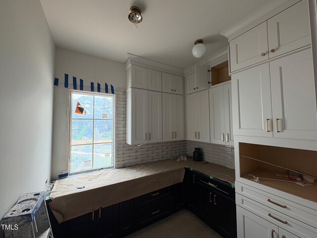 3405 Makers Cir, Raleigh, NC 27612 - kitchen featuring backsplash, white cabinets, and light countertops