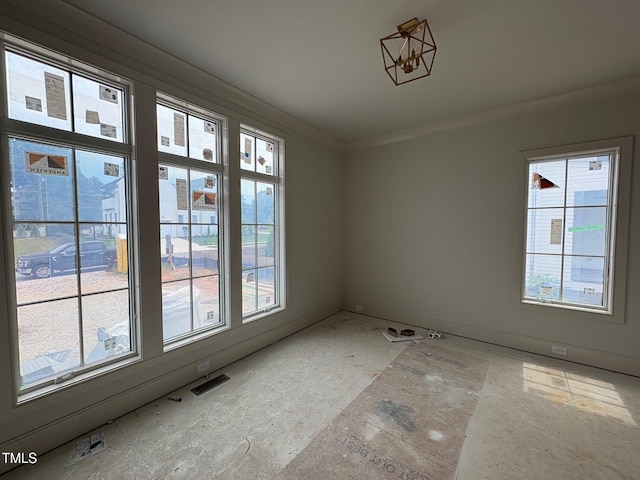 3405 Makers Cir, Raleigh, NC 27612 - empty room featuring healthy amount of natural light, ornamental molding, and baseboards