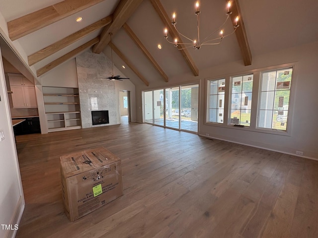3405 Makers Cir, Raleigh, NC 27612 - unfurnished living room with beamed ceiling, a fireplace, a chandelier, wood finished floors, and high vaulted ceiling