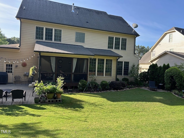 back of property with a patio area, a sunroom, and a yard
