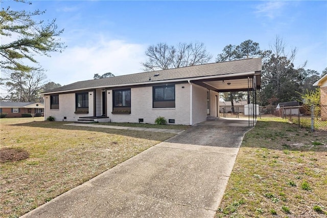 ranch-style house featuring fence, a carport, concrete driveway, a front lawn, and crawl space