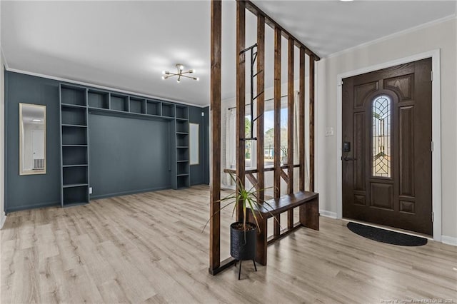 foyer entrance featuring a wealth of natural light, baseboards, wood finished floors, and ornamental molding