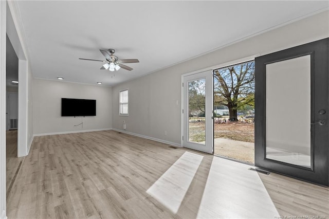 unfurnished living room featuring visible vents, baseboards, light wood-type flooring, and ceiling fan