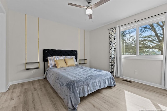 bedroom featuring visible vents, ceiling fan, light wood-type flooring, and baseboards