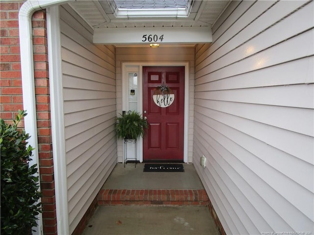 entrance to property featuring brick siding