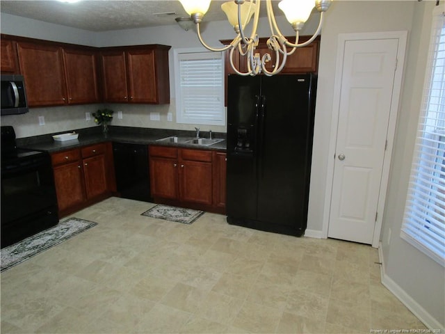 kitchen with dark countertops, visible vents, a chandelier, black appliances, and a sink