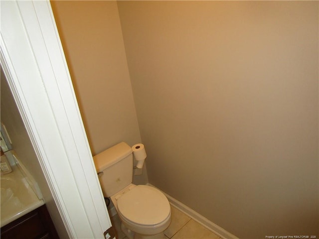 bathroom featuring vanity, tile patterned floors, toilet, and baseboards