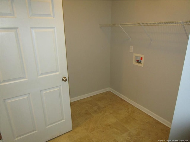 washroom featuring laundry area, hookup for a washing machine, and baseboards