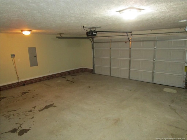 garage with electric panel, a garage door opener, and baseboards