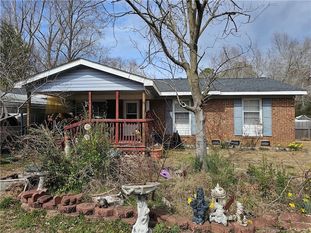 view of front of house with brick siding and covered porch