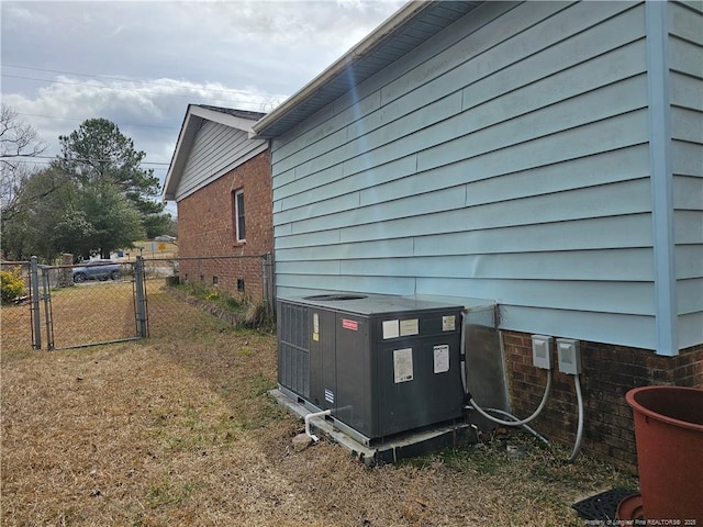 exterior details with crawl space, cooling unit, fence, and a gate