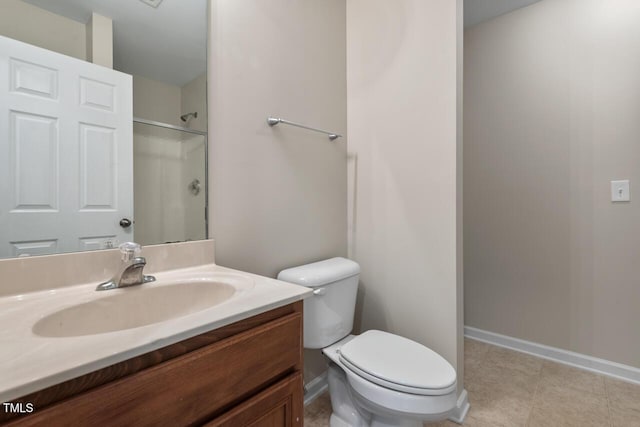 full bathroom with vanity, baseboards, a shower, and toilet