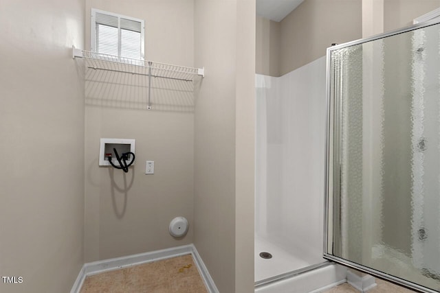 washroom featuring washer hookup and baseboards
