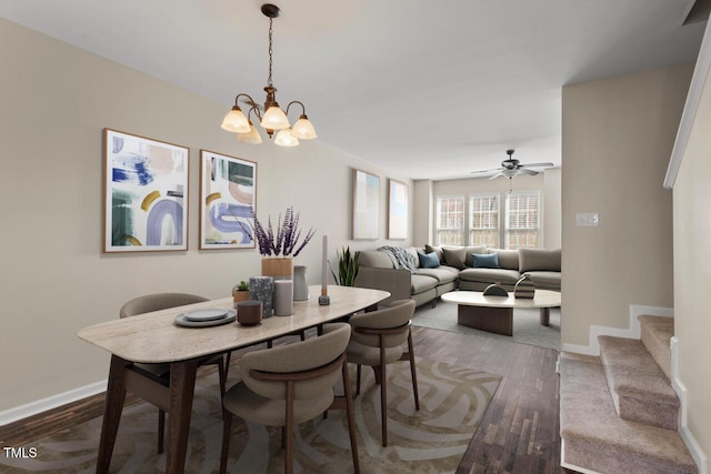 dining room with stairway, baseboards, ceiling fan with notable chandelier, and dark wood finished floors