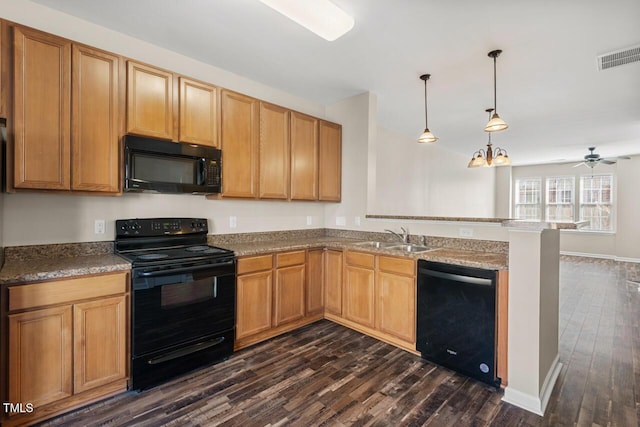 kitchen featuring visible vents, a sink, black appliances, a peninsula, and dark wood-type flooring