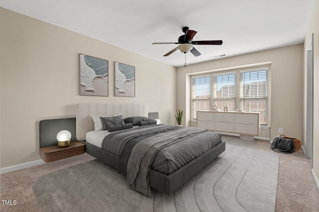 carpeted bedroom with baseboards and ceiling fan