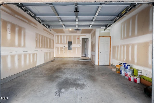 garage with a garage door opener and electric panel