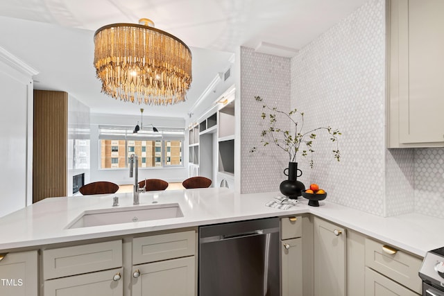 kitchen featuring a chandelier, dishwasher, a sink, and light countertops