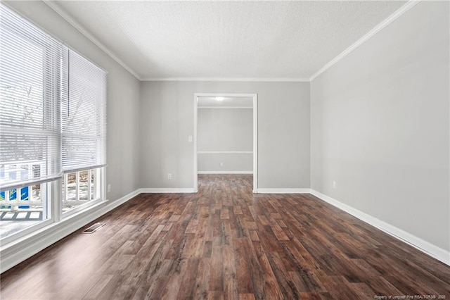 spare room with crown molding, baseboards, and dark wood-style flooring