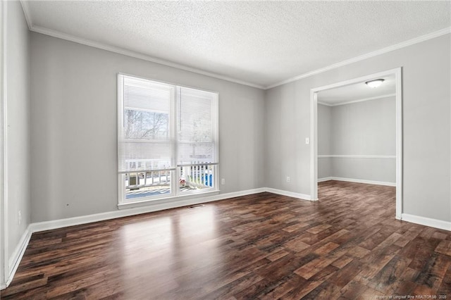 empty room featuring ornamental molding, a textured ceiling, baseboards, and wood finished floors