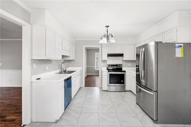 kitchen featuring light countertops, ornamental molding, marble finish floor, stainless steel appliances, and a sink