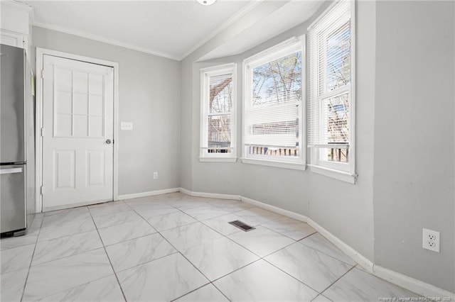 spare room with crown molding, baseboards, visible vents, and marble finish floor