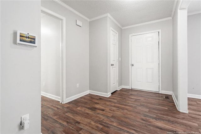 interior space featuring baseboards, dark wood-type flooring, crown molding, and a textured ceiling