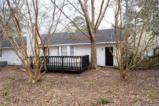 rear view of property featuring a deck, central AC unit, and roof with shingles