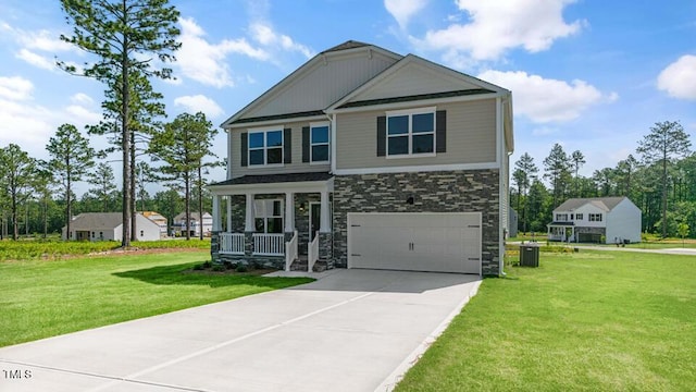 3040 Platinum Cir W, End, NC 27376 - craftsman-style house featuring stone siding, covered porch, a garage, concrete driveway, and a front lawn
