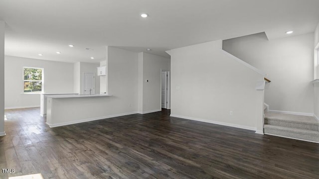 3040 Platinum Cir W, End, NC 27376 - unfurnished living room featuring stairs, dark wood-style flooring, and recessed lighting