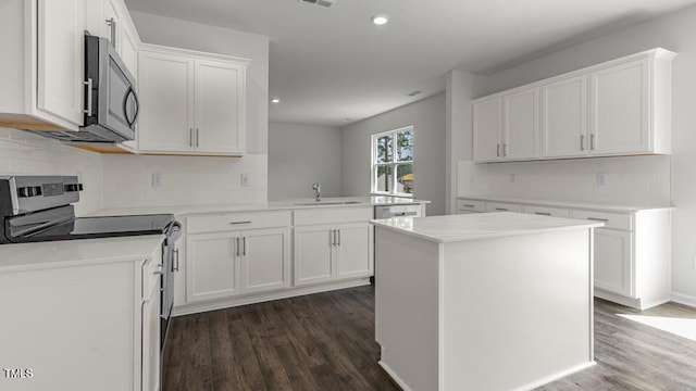 3040 Platinum Cir W, End, NC 27376 - kitchen with stainless steel appliances, dark wood-type flooring, decorative backsplash, recessed lighting, and a peninsula