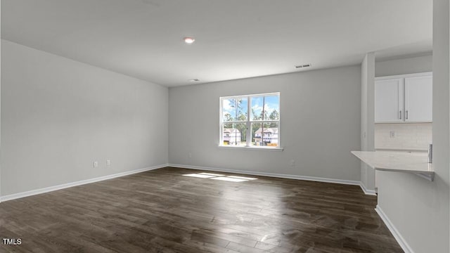 3040 Platinum Cir W, End, NC 27376 - unfurnished living room featuring dark wood-type flooring and recessed lighting