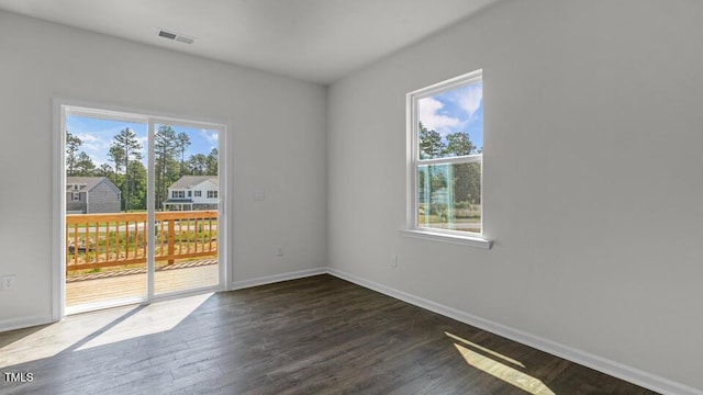 3040 Platinum Cir W, End, NC 27376 - empty room featuring plenty of natural light and dark wood finished floors
