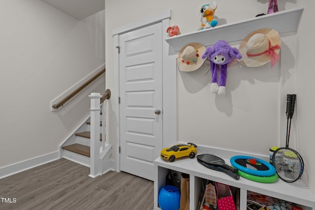 rec room featuring wood finished floors and baseboards