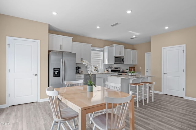 656 Dallas Rose Dr, Wendell, NC 27591 - dining room featuring light wood finished floors, baseboards, visible vents, and recessed lighting