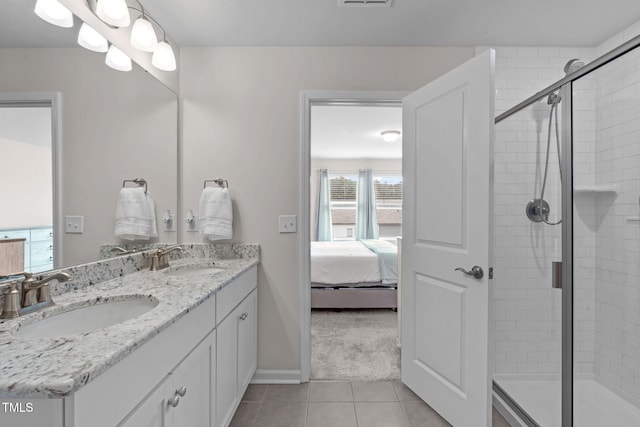 656 Dallas Rose Dr, Wendell, NC 27591 - ensuite bathroom featuring a shower stall, tile patterned floors, a sink, and connected bathroom