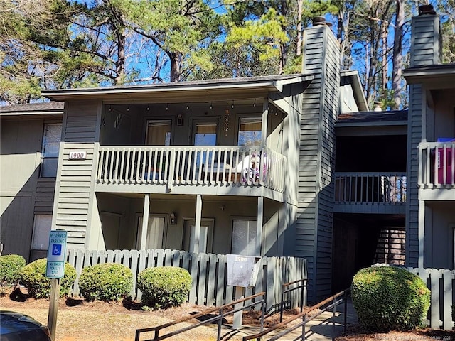 back of house featuring a balcony