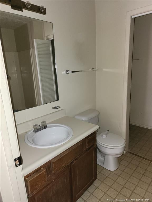 bathroom with toilet and vanity