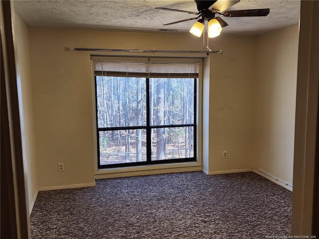 carpeted spare room with baseboards, a textured ceiling, and a ceiling fan