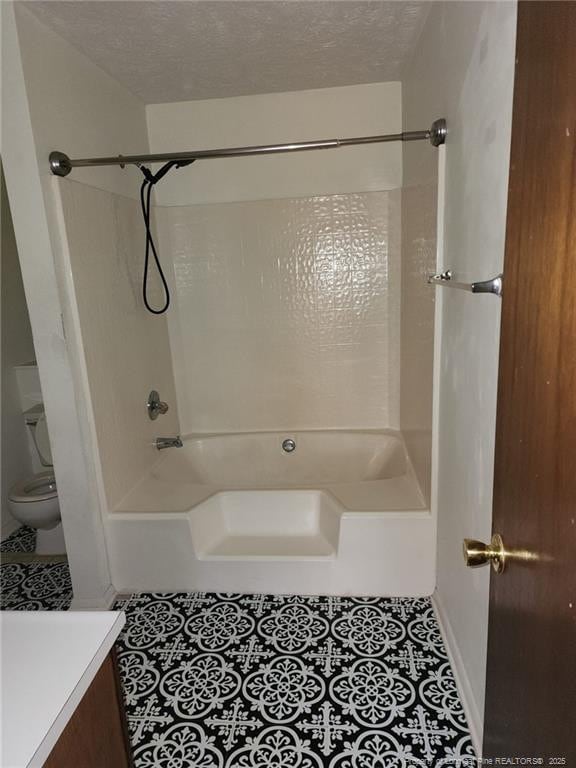 full bath featuring a textured ceiling, toilet, vanity, and tile patterned flooring