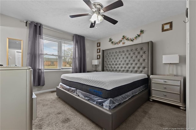 bedroom with a ceiling fan, baseboards, a textured ceiling, and carpet flooring