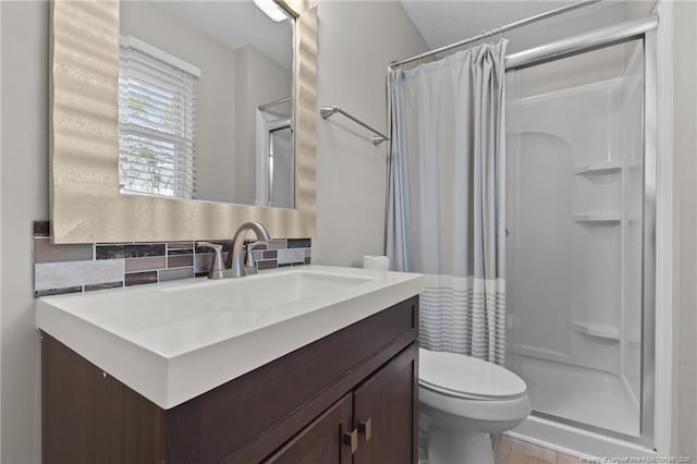 bathroom featuring decorative backsplash, vanity, toilet, and a shower stall