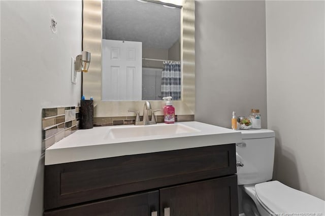 bathroom featuring vanity, a shower with shower curtain, and toilet