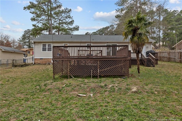 rear view of property with crawl space, a deck, a yard, and a fenced backyard